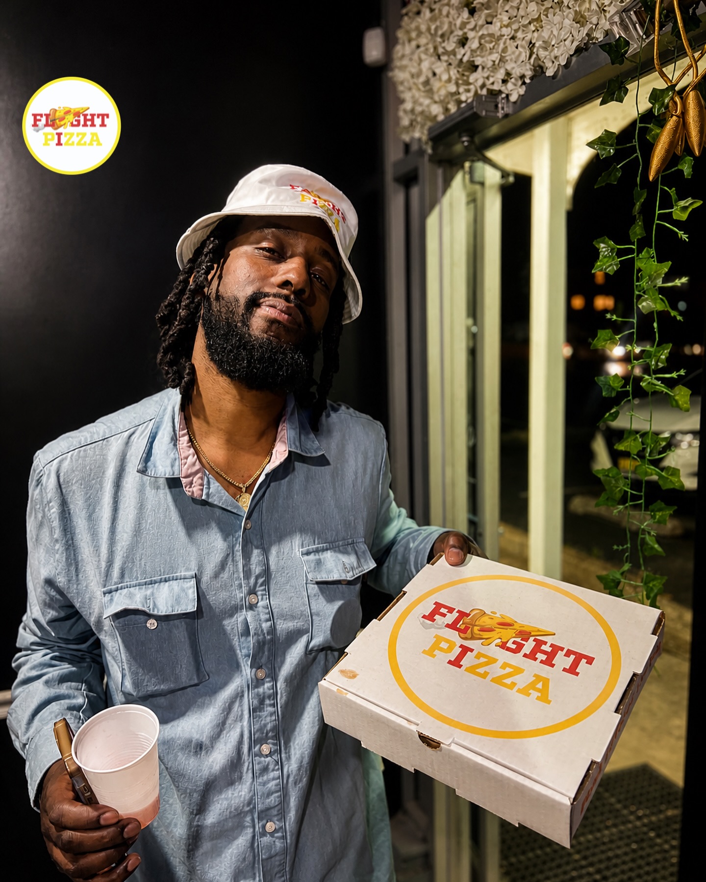 Guest holding a Flyght Pizza box at the pop-up